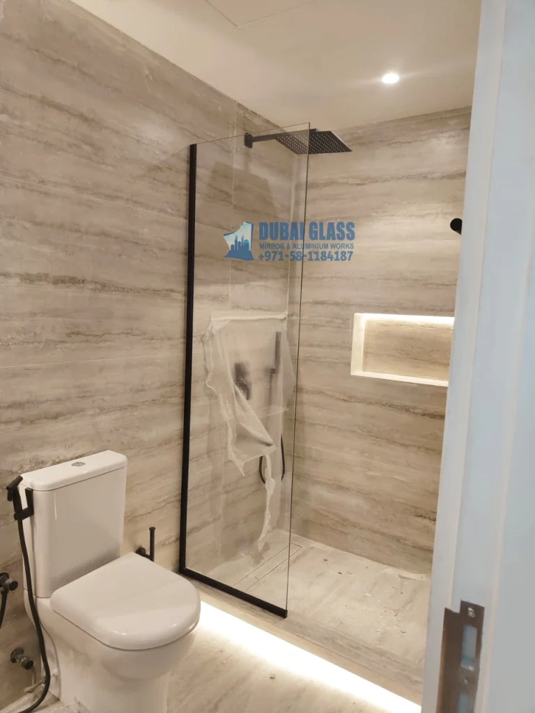 Black frame fixed glass shower screen in modern bathroom