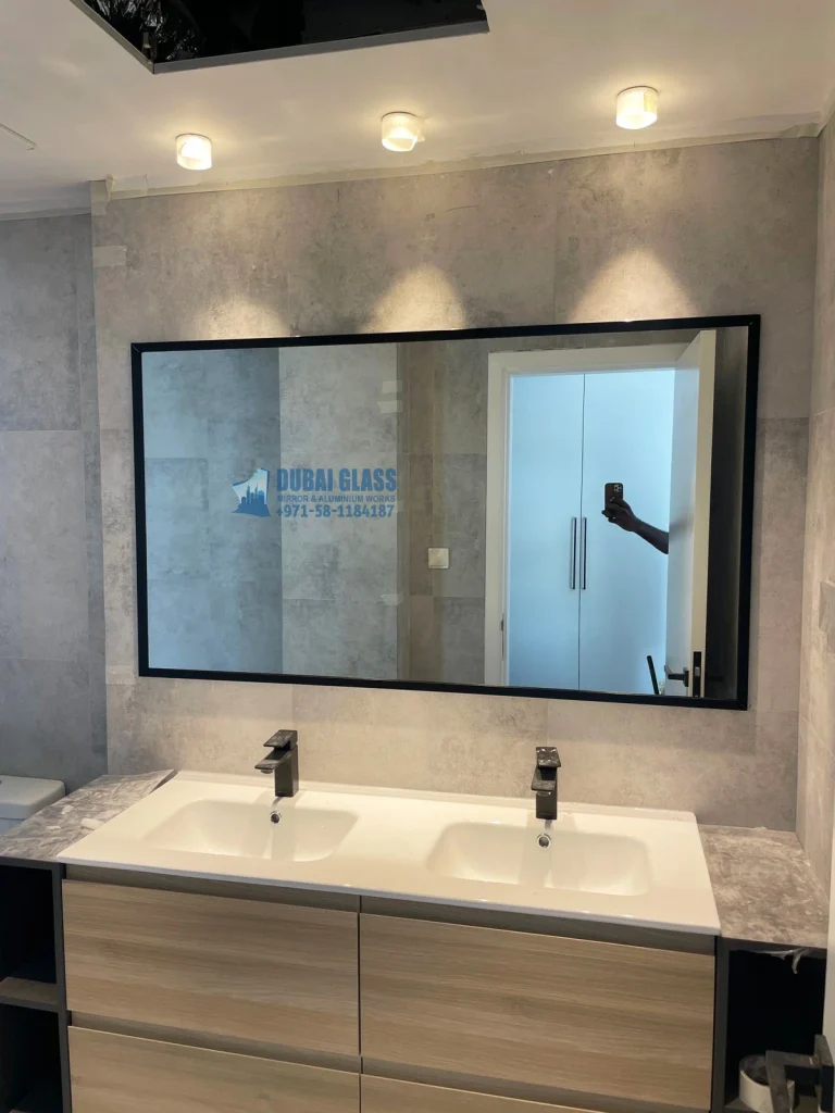 Black frame wall mirror installed in Dubai interior