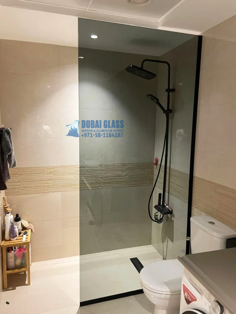 Black shower screen with dark tinted glass in modern bathroom