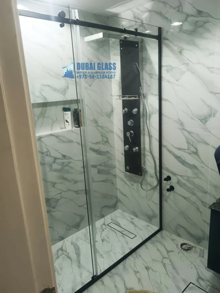 Black sliding shower glass partition in modern bathroom