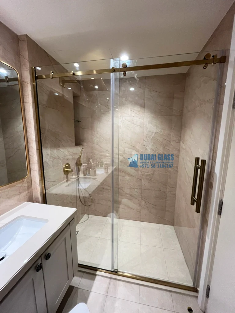 sliding shower glass partition with gold matte frame dubai