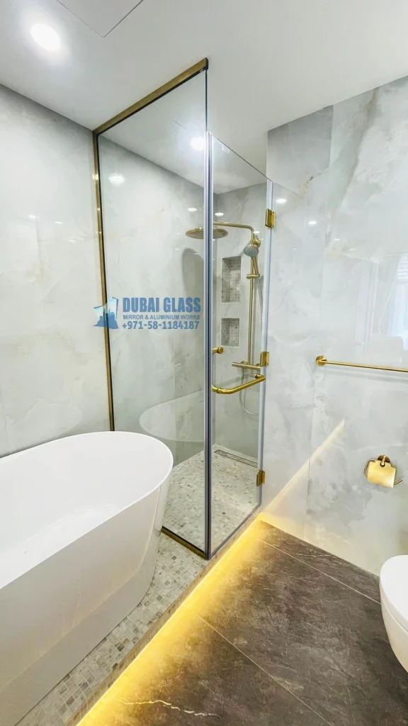 Corner shower glass partition with gold matte finish