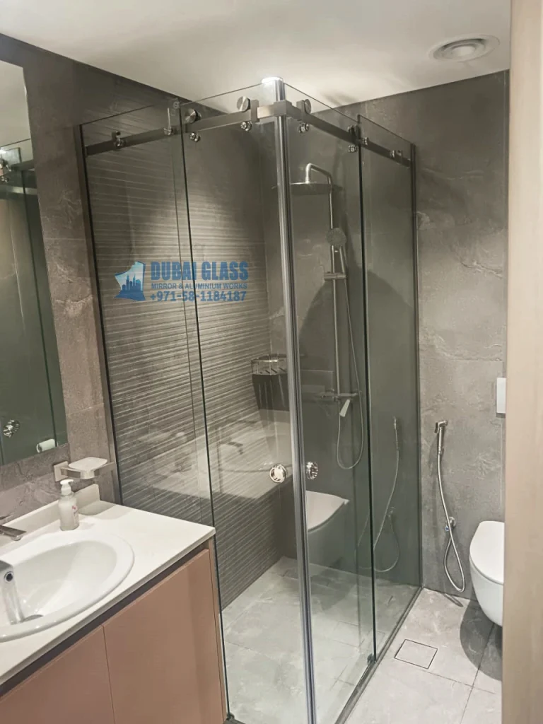 Corner sliding glass shower enclosure with tempered panels
