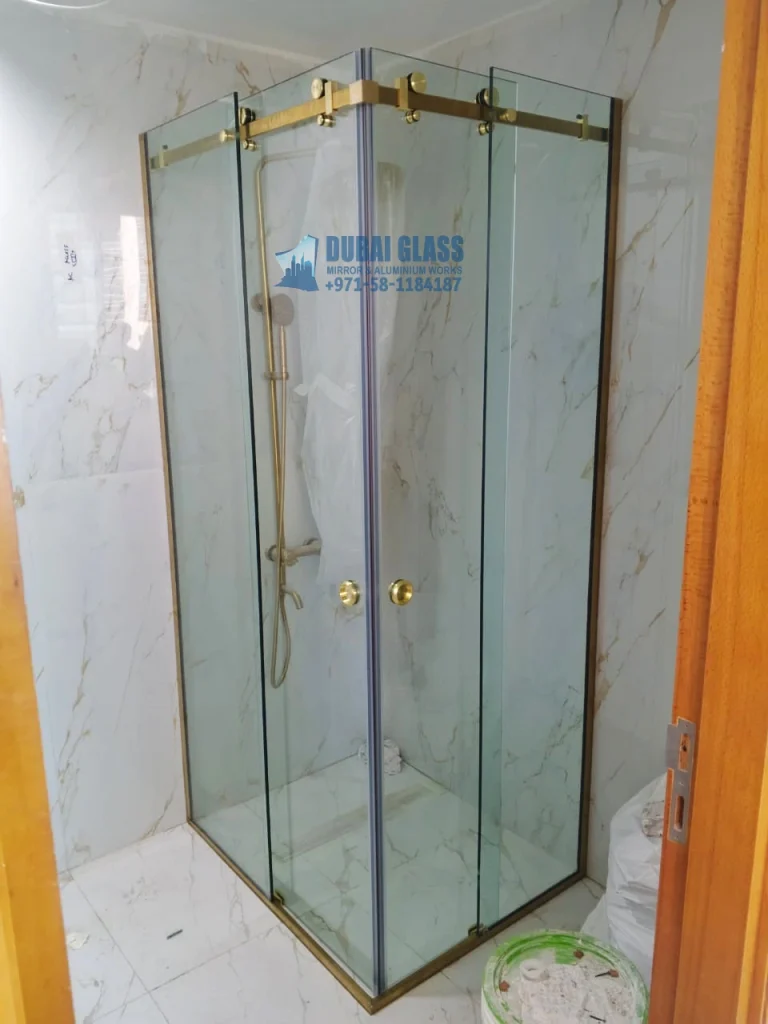 corner sliding golden shower doors in Dubai bathroom – Dubai Glass Works